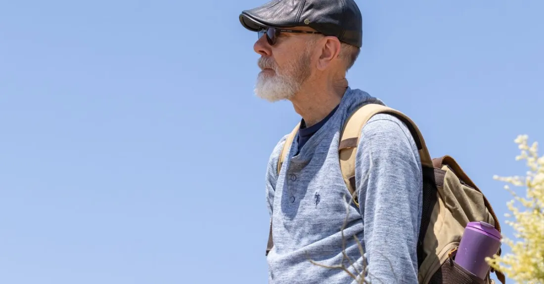 Active man in his 50s hiking outdoors, staying fit as he ages