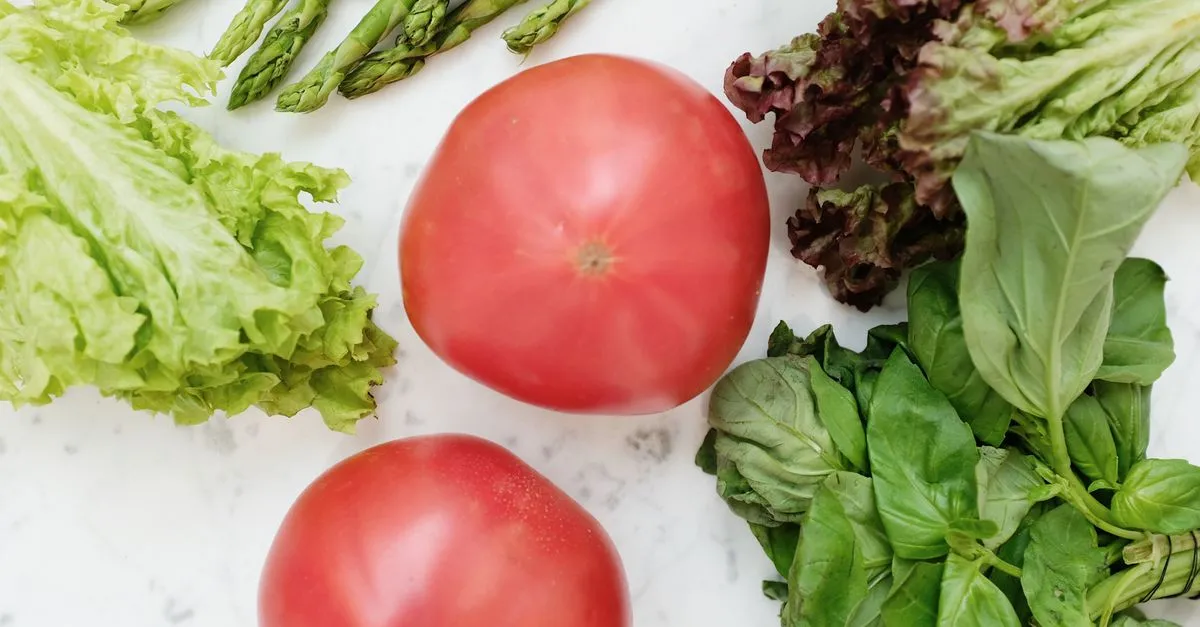 Fresh prostate-healthy foods including tomatoes, leafy greens and asparagus